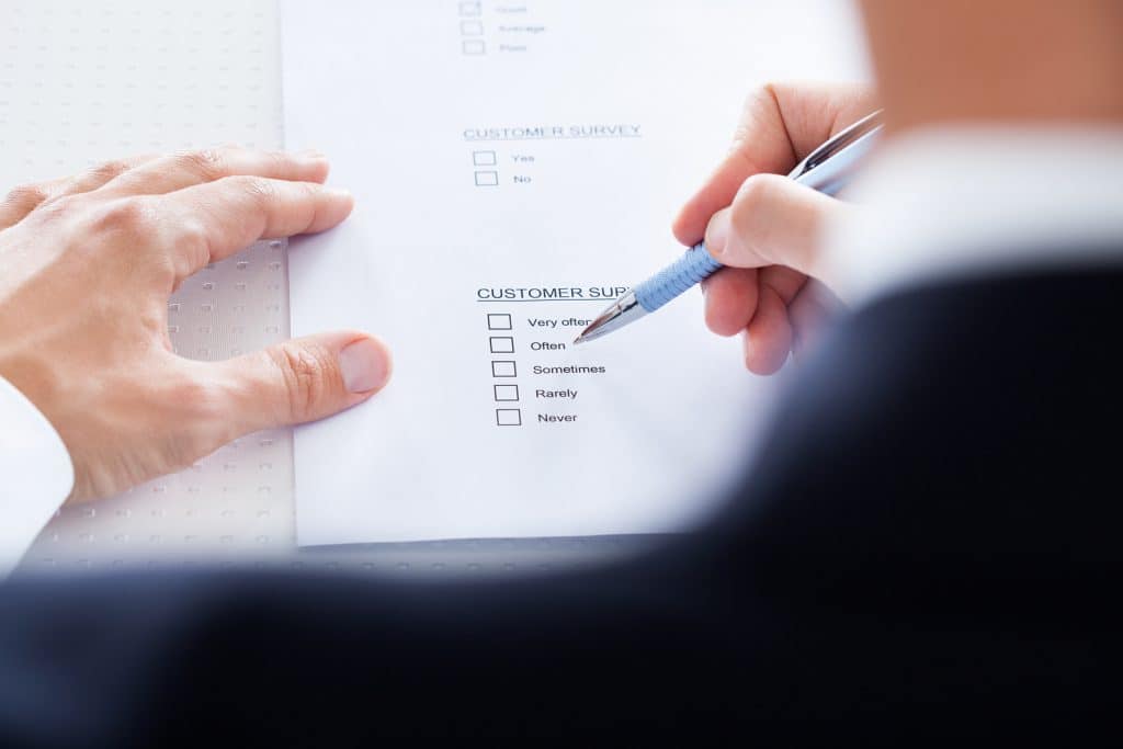 Man taking reader survey sitting at desk