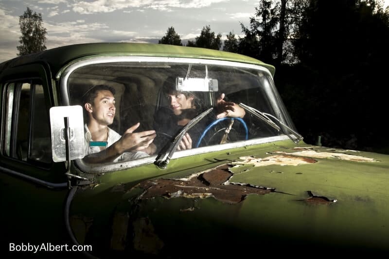 Guys in old truck talking and displaying the concept of principle vs expediency